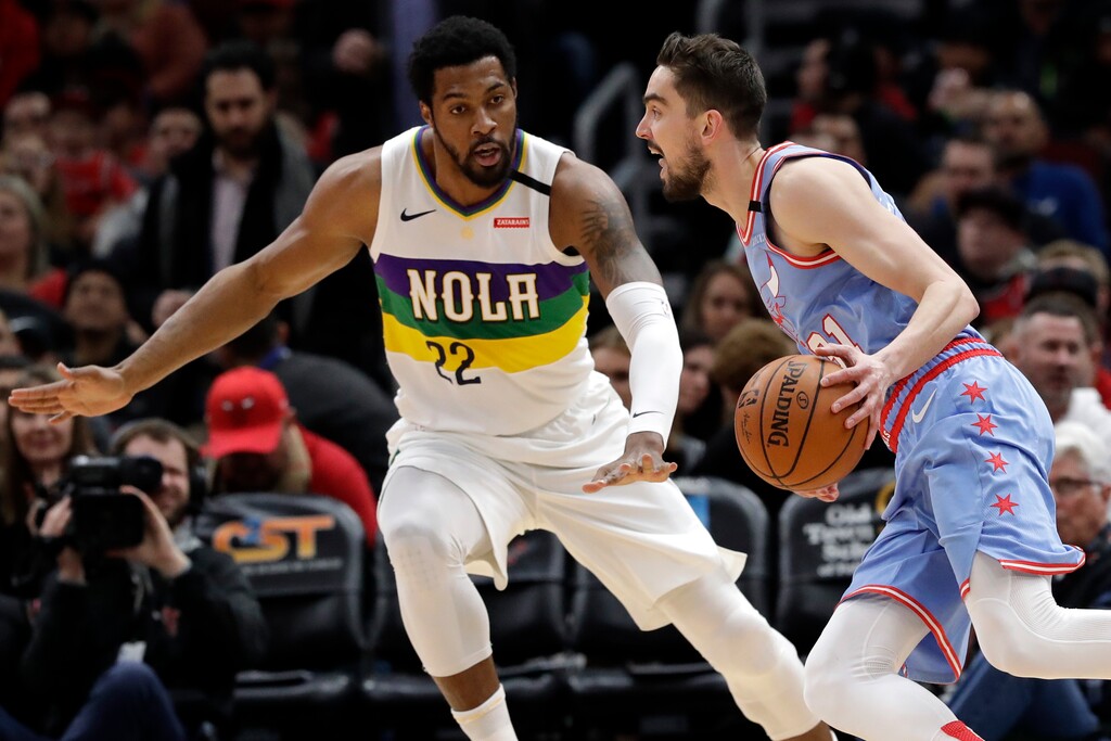Chicago Bulls guard Tomas Satoransky, right, drives against New Orleans Pelicans center Derrick Favors during the first half of an NBA basketball game in Chicago, Thursday, Feb. 6, 2020. (AP Photo/Nam Y. Huh)