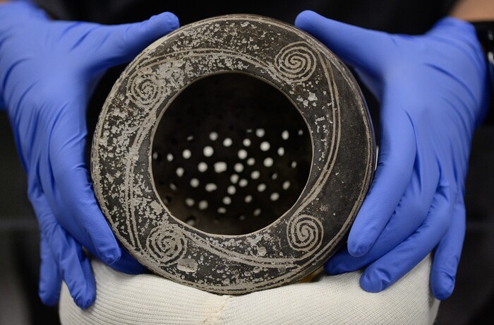(Francisco Kjolseth  |  The Salt Lake Tribune)  Alexandra Greenwald, Curator of Ethnography holds up an Ancestral Puebloan colander on display as part of the annual Behind The Scenes event at The Natural History Museum of Utah on Saturday, Nov. 16, 2019, one of many from the Byron Cunningham collection.
