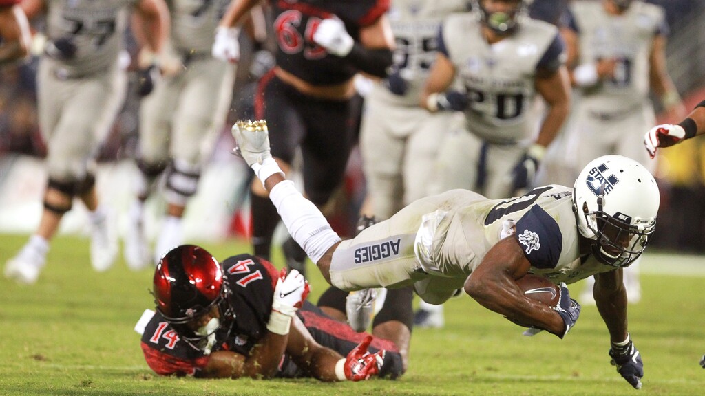 Utah State wide receiver Siaosi Mariner gets tripped by San Diego State's Tariq Thompson after Mariner caught a pass during the second quarter of an NCAA college football game Saturday, Sept. 21, 2019, in San Diego. (Hayne Palmour IV/The San Diego Union-Tribune via AP)