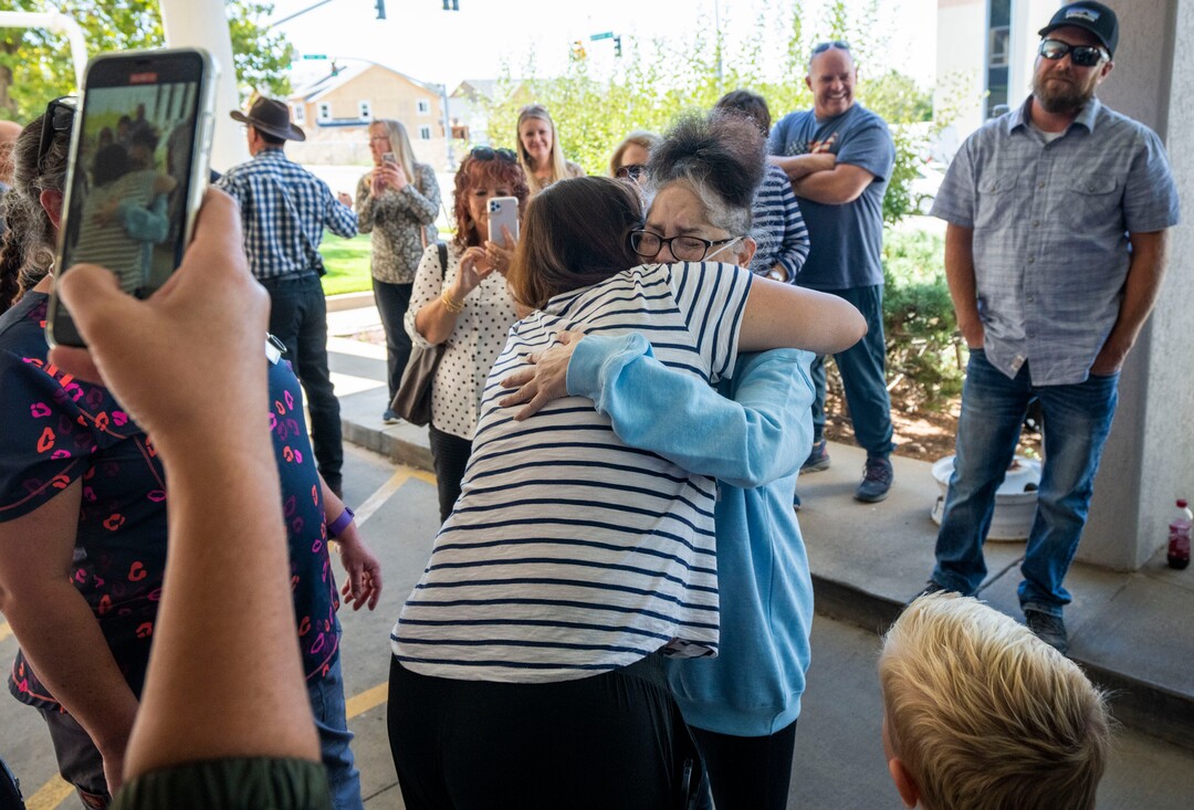 (Rick Egan | The Salt Lake Tribune)  Tina Lewis hugs family members as she leaves the South Davis Community Hospital in Bountiful, Wednesday, Sept. 22, 2021. Lewis heads home to Idaho Falls, Idaho, after spending most of the past 6 months in hospitals sick with COVID-19.