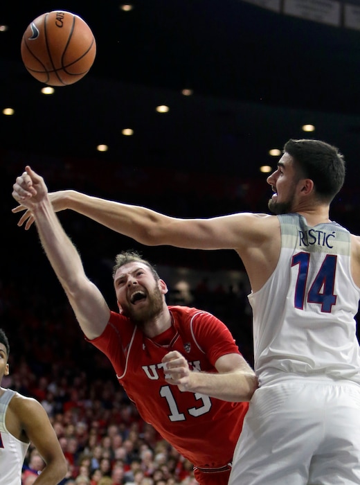Utah forward David Collette (13) shoots while pressured by Arizona center Dusan Ristic in the first half during an NCAA college basketball game, Saturday, Jan. 27, 2018, in Tucson, Ariz. (AP Photo/Rick Scuteri)
