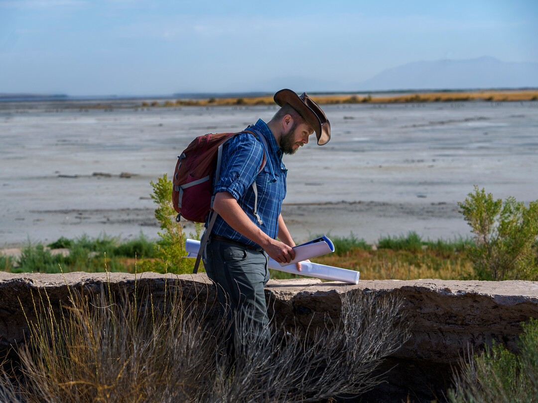 (Leah Hogsten | The Salt Lake Tribune) Christopher Merritt, a state historic preservation officer, points out the original  sea wall near the former location of Saltair, Thursday, July 21, 2022. The seawall was built in the 1920s to keep the salty water of the Great Salt Lake from compromising the train line that serviced the resort. 