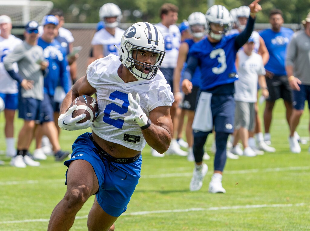 (Rick Egan | The Salt Lake Tribune)  Christopher Brooks runs the ball during a scrimmage, on day 1 of BYU Football Fall Camp, on Thursday, Aug. 4, 2022.