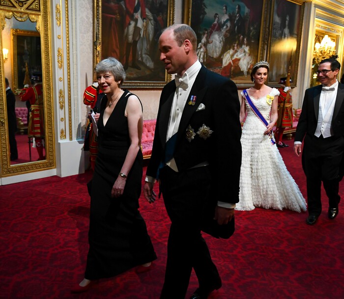 Britain's Prime Minister Theresa May, left and Prince William, Duke of Cambridge, followed by Kate, the Duchess of Cambridge and United States Secretary of the Treasury, Steven Mnuchin,  arrive through the East Gallery ahead of the State Banquet at Buckingham Palace in London, Monday, June 3, 2019.  US President, Donald Trump is on a three-day state visit to Britain. (Victoria Jones/Pool Photo via AP)