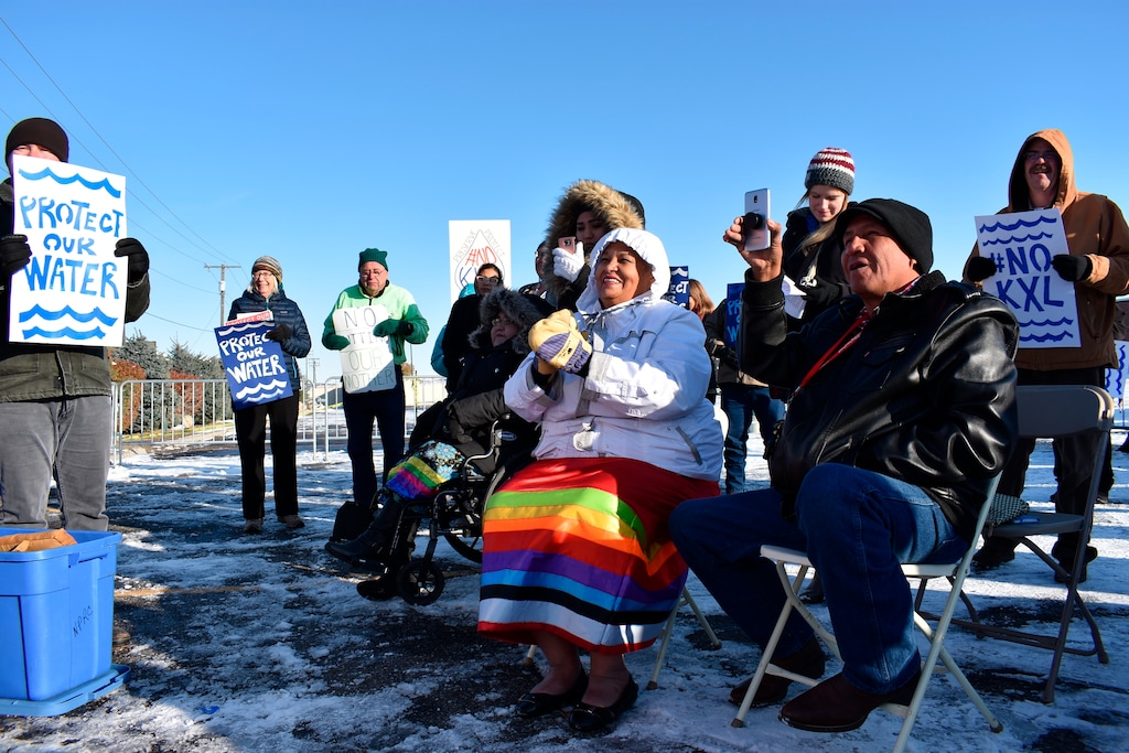 (Matthew Brown | AP) In this Oct. 29, 2019, file photo, opponents of the Keystone XL oil pipeline from Canada demonstrate in sub-freezing temperatures in Billings, Mont. Major construction projects moving forward along the U.S. borders with Canada and Mexico amid the coronavirus pandemic are raising fears workers could spread infections within nearby communities, including several Native American tribes. Several of the tribes whose land is skirted by the proposed pipeline route in South Dakota and Montana have enacted stricter measures than the state to protect tribal members from the coronavirus.