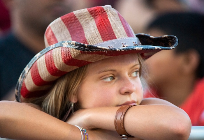 (Rick Egan  |  The Salt Lake Tribune)     Ella Vostraas, 13, from Cedar Hills watches the West Jordan Western Stampede Rodeo, Saturday, July 6, 2019.