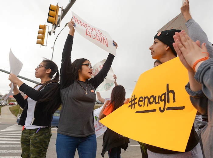 (Leah Hogsten  |  The Salt Lake Tribune) l-r East High School students Nathalie Luna, Brenda Perez and Brandon Garcia took to the corner of 13th East and 800 South to raise awareness of their push for change. Exactly one month after 17 people were killed at Marjory Stoneman Douglas High School in Parkland, survivors of the massacre joined tens of thousands of students across the United States by walking out of school,  Wednesday, March 14, 2018. 