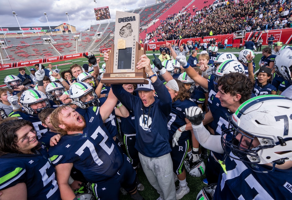 (Rick Egan | The Salt Lake Tribune) Ridgeline head coach Travis Cox hoists the trophy above his head, as he celebrates the Riverhawks 4A Championship, after defeating the Dixie Flyers, at Rice-Eccles Stadium, on Friday, Nov. 12, 2021.