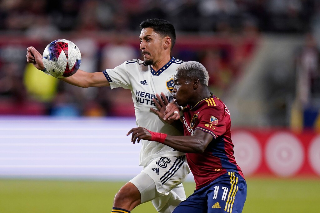 LA Galaxy midfielder Marco Delgado (8) and Real Salt Lake forward Carlos Andrés Gómez (11) vie for the ball during the second half of an MLS soccer match Wednesday, May 31, 2023, in Sandy, Utah. (AP Photo/Rick Bowmer)