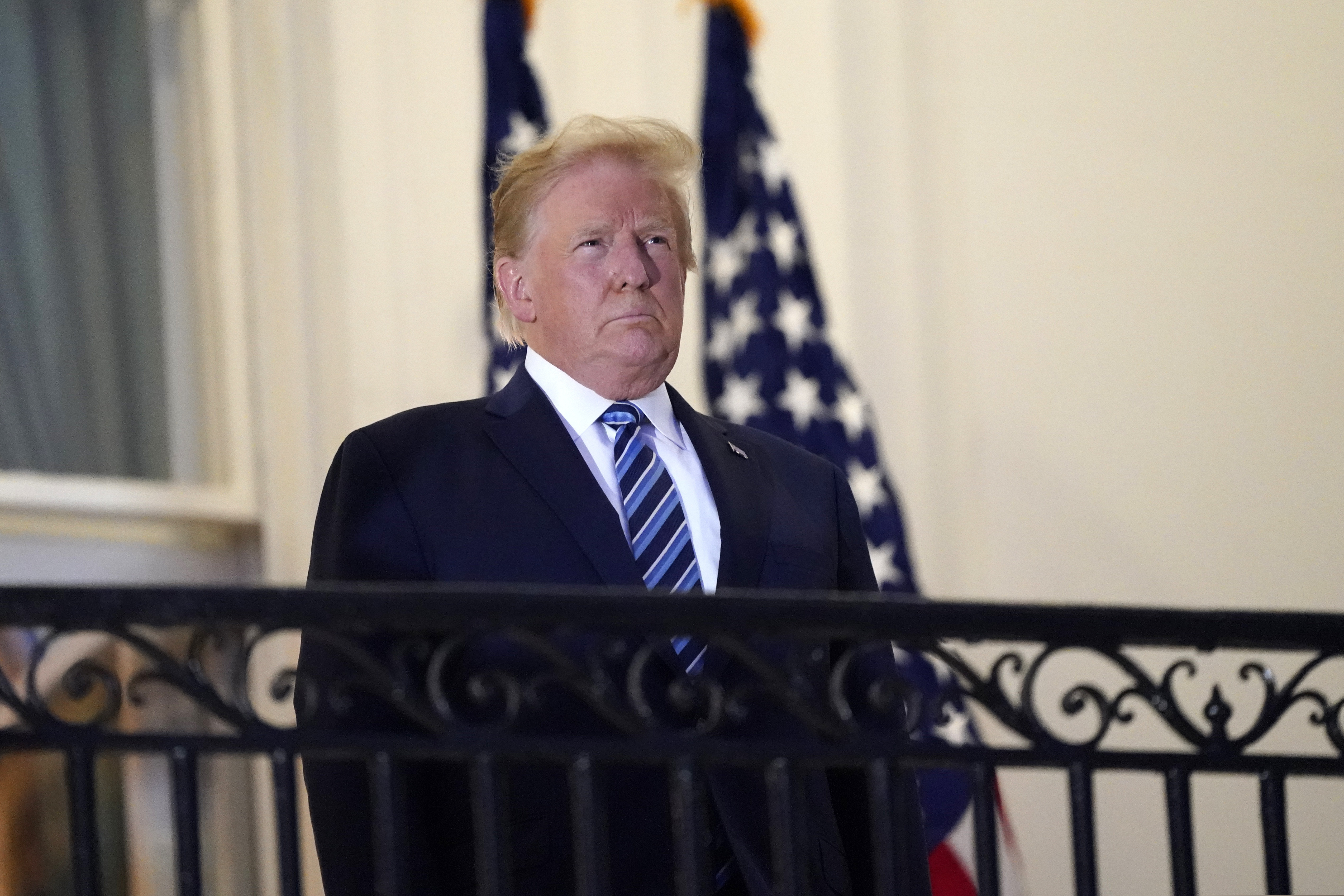 (Alex Brandon | AP file photo) President Donald Trump stands on the balcony outside of the Blue Room as he returns to the White House on Oct. 5, in Washington, after leaving Walter Reed National Military Medical Center.