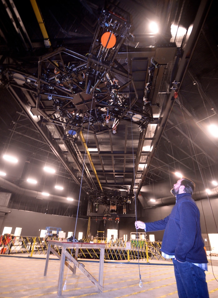 (Al Hartmann | The Salt Lake Tribune) Kacey Udy, Hale Centre Theatre production designer, checks out the "Bogie," a complicated device that runs along rails above the main stage and raises and lowers set pieces to the stage below. It's state-of- the-art equipment for the new facility in Sandy. He's working to help stage "Aida," the first show at the new $80 million theater.