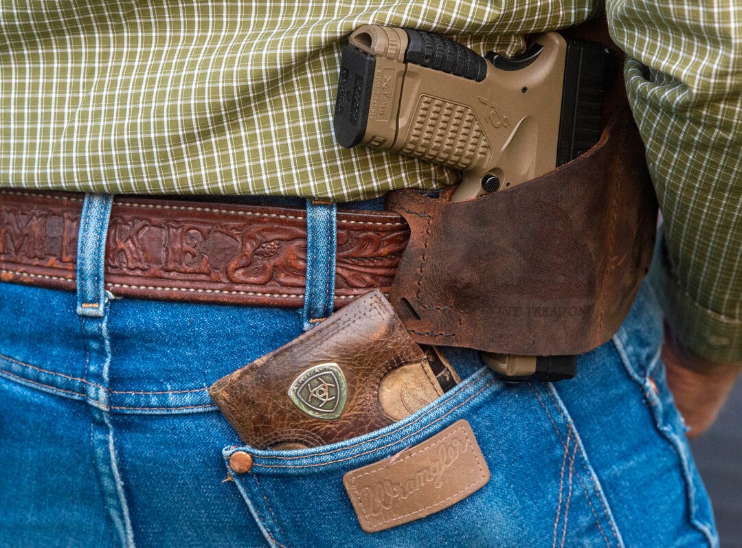 (Rick Egan  |  The Salt Lake Tribune)     Several people carried guns, but no one was wearing masks, as a couple of hundred people gather at the Provo Courthouse for the Utah County Freedom Rally on Friday, Oct. 2, 2020.