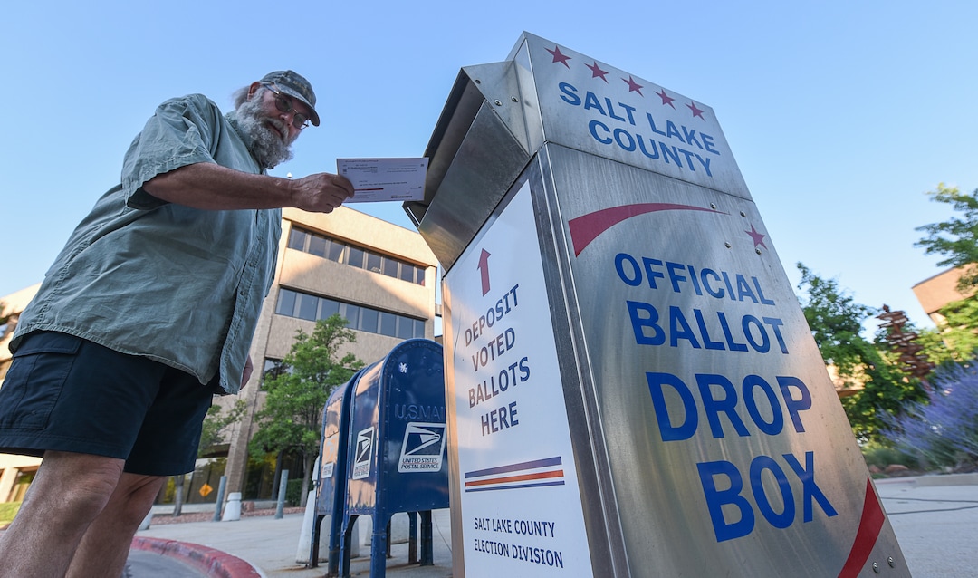 (Francisco Kjolseth  |  The Salt Lake Tribune)  Dave Sawatzki drops his election ballot in the official drop box at the Salt Lake County complex for primary election day on Tuesday, June 26, 2018.