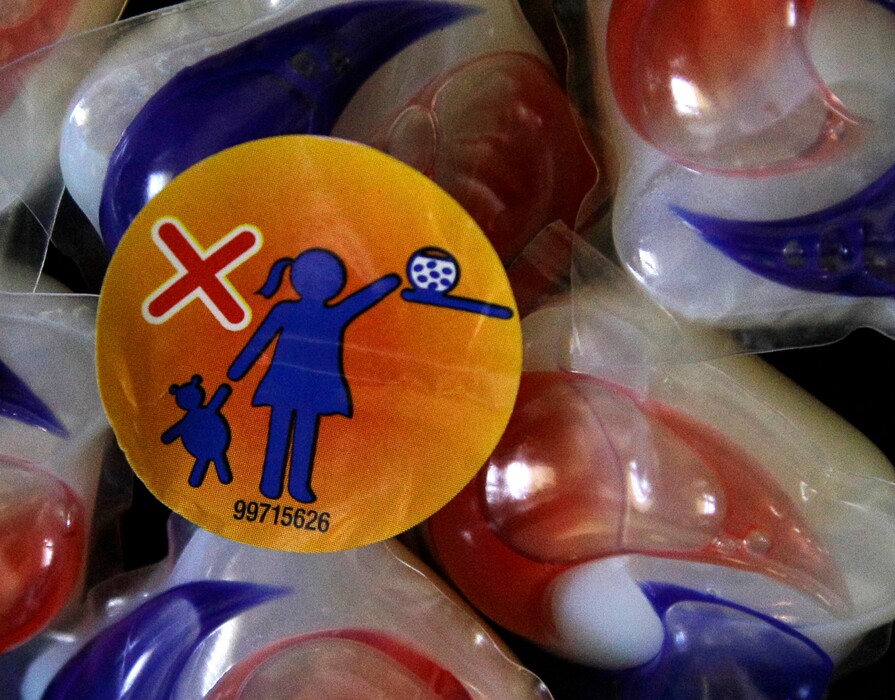 (Pat Sullivan | The Associated Press) A warning label is attached to a package of Tide laundry detergent packets in Houston on Thursday, May 24, 2012. The miniature detergent packets arrived on store shelves in recent months, touted as a solution to bulky bottles and messy spills. But doctors across the country say children are confusing the tiny, brightly colored packets with candy and swallowing them. Nearly 250 cases have been reported to poison control centers.