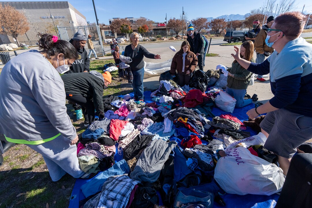 (Rick Egan | The Salt Lake Tribune) Clothing donations are handed out to those in need during a "Gratitude Dinner" served by Dave John and volunteers from the group Black Lives for Humanity, on 500 West in Salt Lake City, on Thursday, Nov. 25, 2021. The group served   to more than 100 people from the unsheltered population, with donations from the community, and many more had food delivered to them by volunteers at camps around the city.