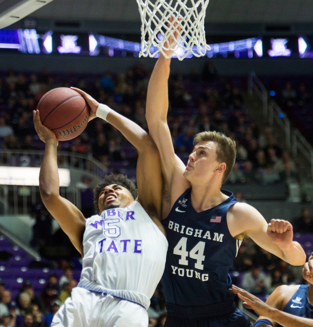 (Rick Egan  |  The Salt Lake Tribune)       Weber State Wildcats guard Cody John (5) takes the ball to the hoop, as Brigham Young Cougars guard Connor Harding (44) defends, in basketball action  between Brigham Young Cougars and Weber State Wildcats, at the Dee Event Center in Ogden, Saturday, Dec. 1, 2018.