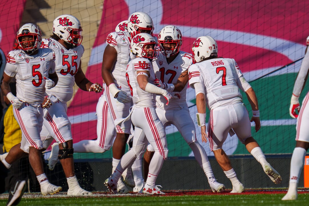 (Trent Nelson  |  The Salt Lake Tribune) Utah Utes quarterback Cameron Rising (7) and Utah Utes wide receiver Britain Covey (18) celebrate a first quarter touchdown as the Utah Utes face the Ohio State Buckeyes at the Rose Bowl in Pasadena, Calif., on Saturday, Jan. 1, 2022.