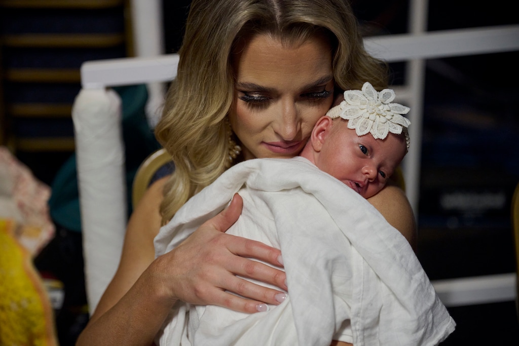 (Bridget Bennett | The New York Times) Hannah Neeleman, last year’s Mrs. American pageant winner, holds her newborn daughter, Flora Jo, after the Mrs. World beauty pageant at the Westgate Hotel and Casino in Las Vegas, Jan. 21, 2024. Like many online influencers, Neeleman has successfully monetized her popularity. With that success, however, has come scrutiny. And now the Latter-day Saint mother of eight is pushing back on what she says was a biased attempt by a journalist to paint her as the submissive wife to a controlling, if devoted, husband.