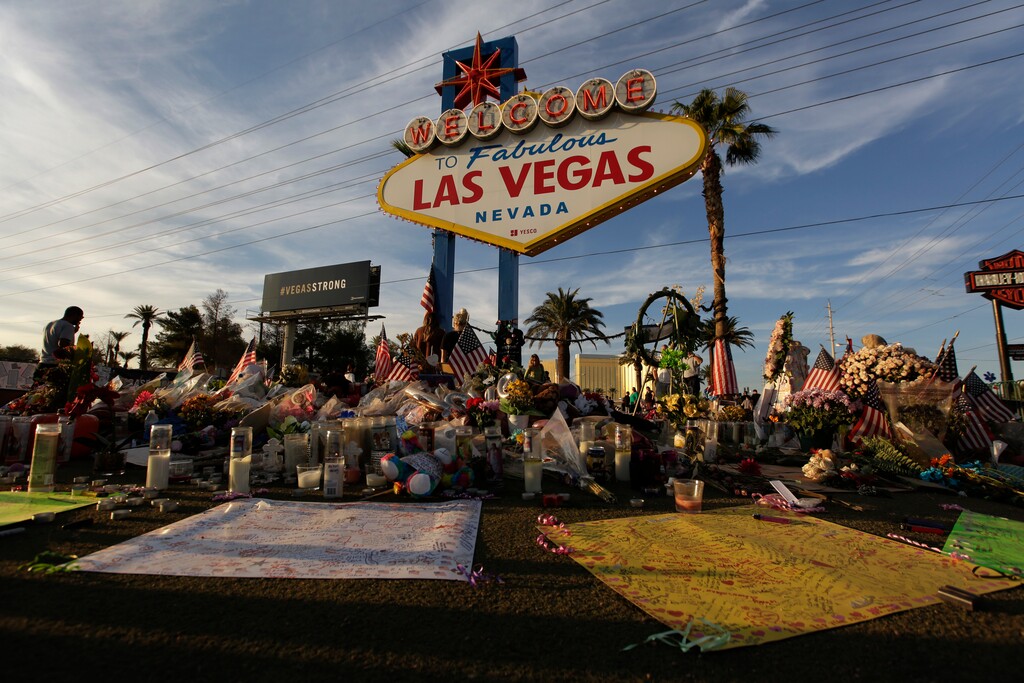 (John Locher | The Associated Press) People visit a makeshift memorial for victims of the mass shooting in Las Vegas, Monday, Oct. 16, 2017, in Las Vegas.
