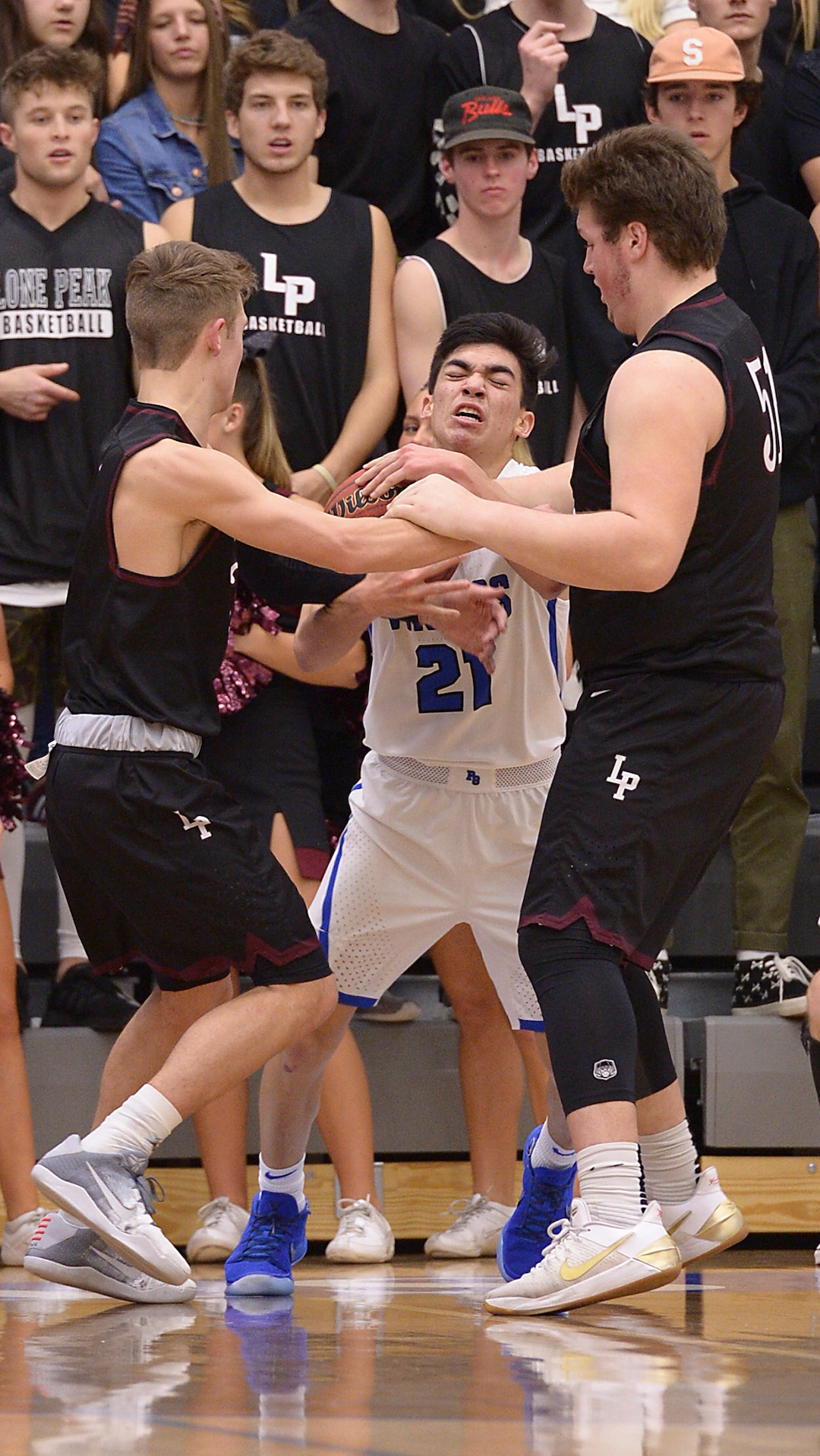 (Leah Hogsten  |  The Salt Lake Tribune) Pleasant Grove's Kawika Akina fights for possession.  Pleasant Grove High School boys' basketball team leads Lone Peak High School 26-20 during their game Friday, January 26, 2018 in Pleasant Grove. 