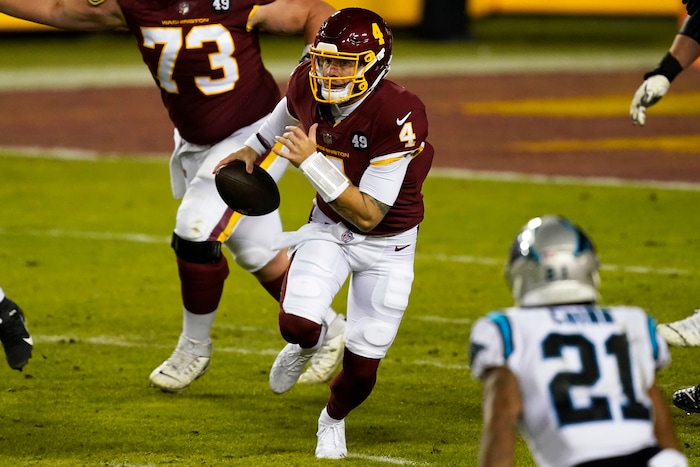 Washington Football Team quarterback Taylor Heinicke scrambles during an NFL football game against the Carolina Panthers, Sunday, Dec. 27, 2020, in Landover, Md. Until a relief appearance Sunday, Heinicke hadn't played an NFL game since 2018 and was an XFL backup, and now Heinicke could start or be one Alex Smith injury away in the season finale at Philadelphia with the NFC East on the line.(AP Photo/Mark Tenally)
