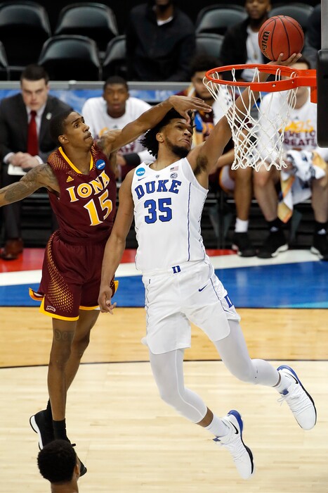 Duke's Marvin Bagley III (35) makes a shot with Iona's Deyshonee Much (15) defending during the first half of an NCAA men's college basketball tournament first-round game, in Pittsburgh, Thursday, March 15, 2018.(AP Photo/Gene J. Puskar)