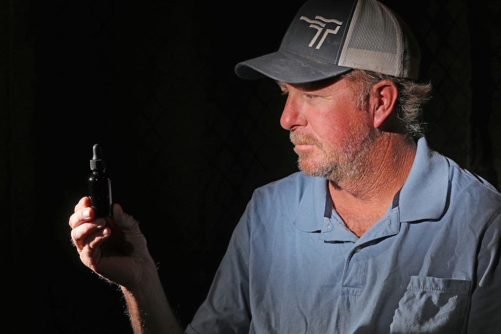 (Rick Bowmer | AP) Mitch Hill, 48, holds a bottle of tincture at his home Thursday, Oct. 24, 2019, in West Jordan. A law passed by the Utah Legislature in Dec. 2018, allows residents to use medical marijuana before patient cards are officially doled out, which is expected to happen in March 2020 at the earliest, but they must obtain a signed letter of recommendation from a doctor physician's assistant or other medical provider.