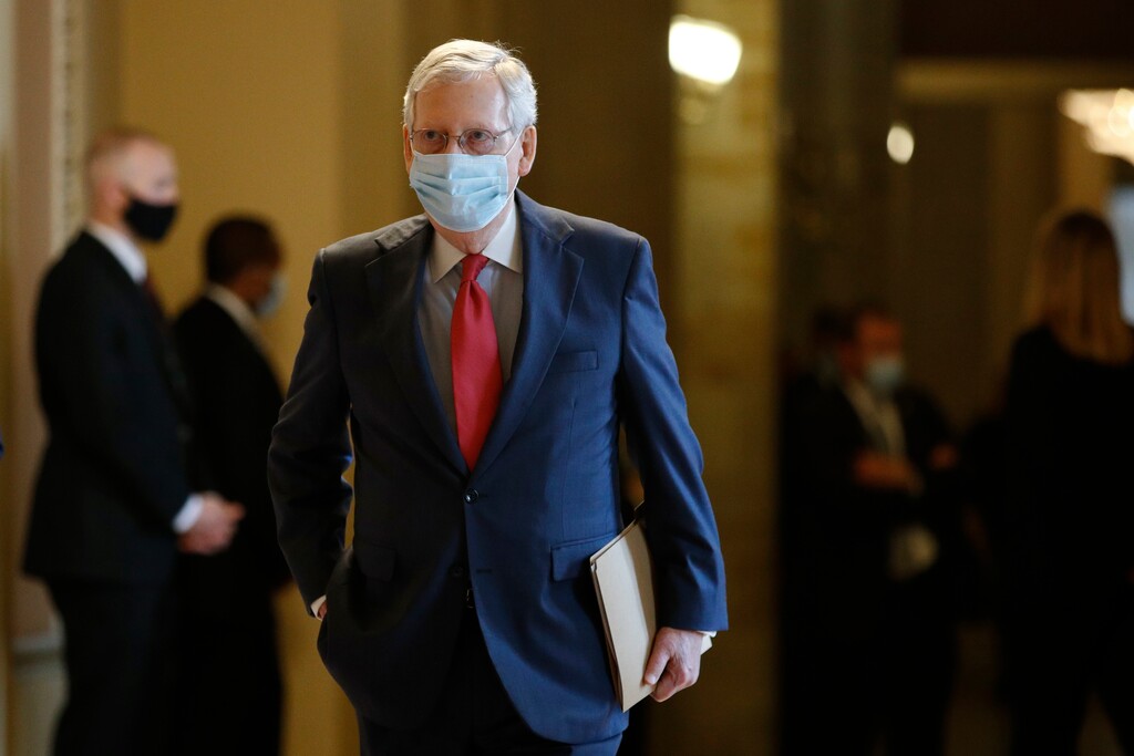 (Patrick Semansky | The Associated Press) Senate Majority Leader Mitch McConnell of Ky., wears a face mask to protect against the spread of the new coronavirus as he walks to the Senate chamber after meeting with Vice President Mike Pence and Treasury Secretary Steve Mnuchin on Capitol Hill in Washington, Tuesday, May 19, 2020.