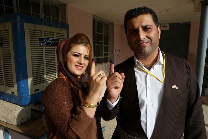 Iraqi Kurdish man and woman show their inked fingers after casting a vote during the referendum on independence from Iraq in Irbil, Iraq, Monday, Sept. 25, 2017. Iraq's Kurdish region vote in a referendum on whether to secede from Iraq. (AP Photo/Khalid Mohammed)