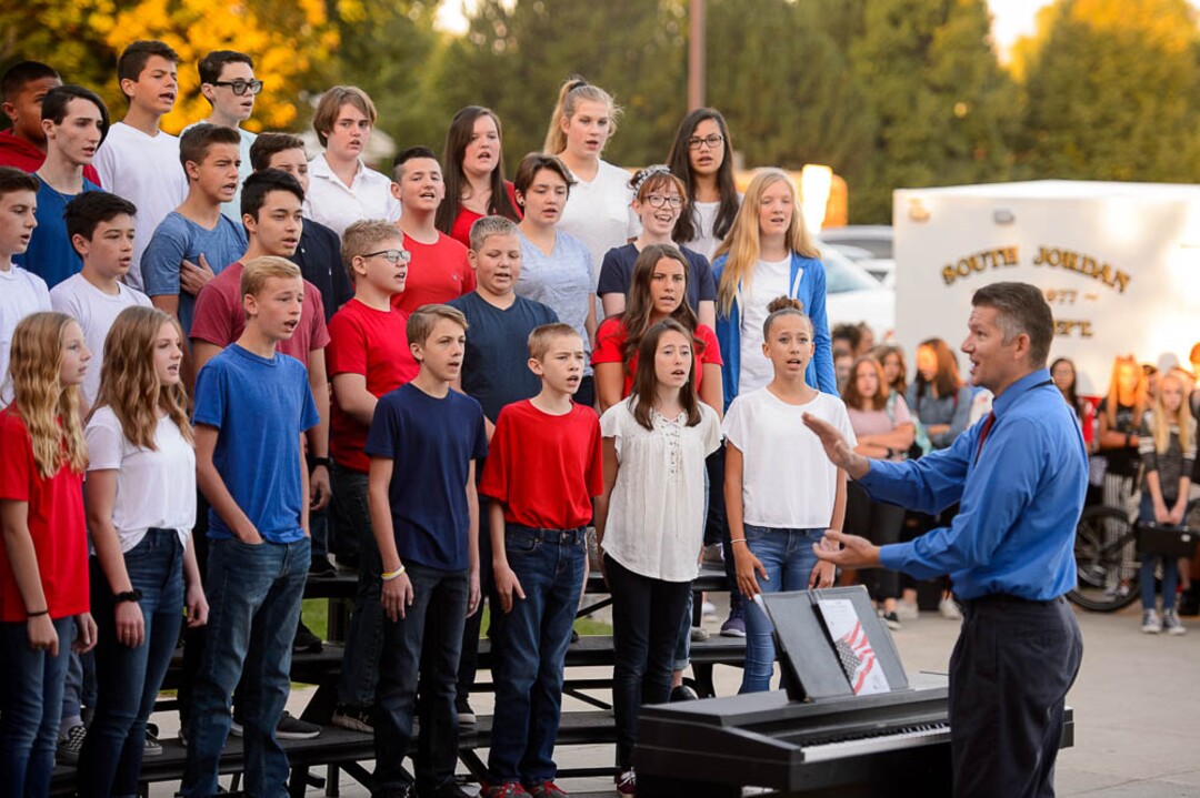 (Trent Nelson | The Salt Lake Tribune)  Students in the South Jordan Middle School Concert Choir sing at a sunrise ceremony to mark the anniversary of 9/11, Tuesday Sept. 11, 2018. Conducting is Shawn Kidd.