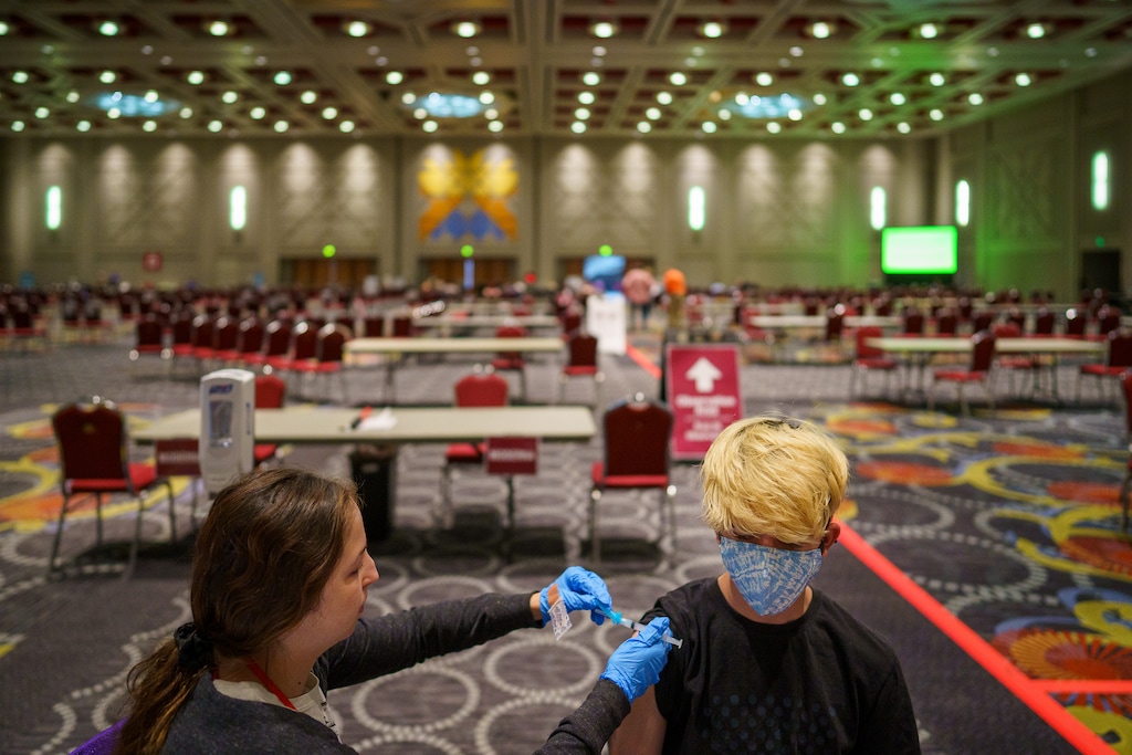 (Trent Nelson | The Salt Lake Tribune) Taylor Starr vaccinates Matt Cox in the grand ballroom at the Salt Palace Convention Center in Salt Lake City, Saturday, May 29, 2021.