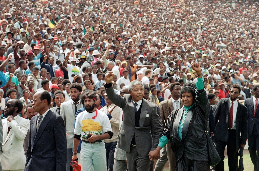 FILE - In this Feb. 13, 1990, file photo, Nelson Mandela and Winnie Mandela give black power salutes as they enter Soccer City stadium in the Soweto township of Johannesburg, South Africa, shortly after his release from 27 years in prison. Mandela went on to become the country's first black president after the country's first all race elections in 1994. (AP Photo/Udo Weitz, File)