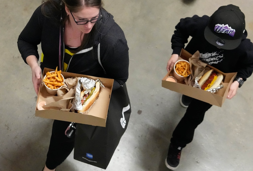 (Francisco Kjolseth  |  The Salt Lake Tribune) Utah Jazz fans carry their concession food choices before the start of the Utah Jazz game against the Orlando Magic at the Delta Center in Salt Lake City on Thursday, Nov. 2, 2023.