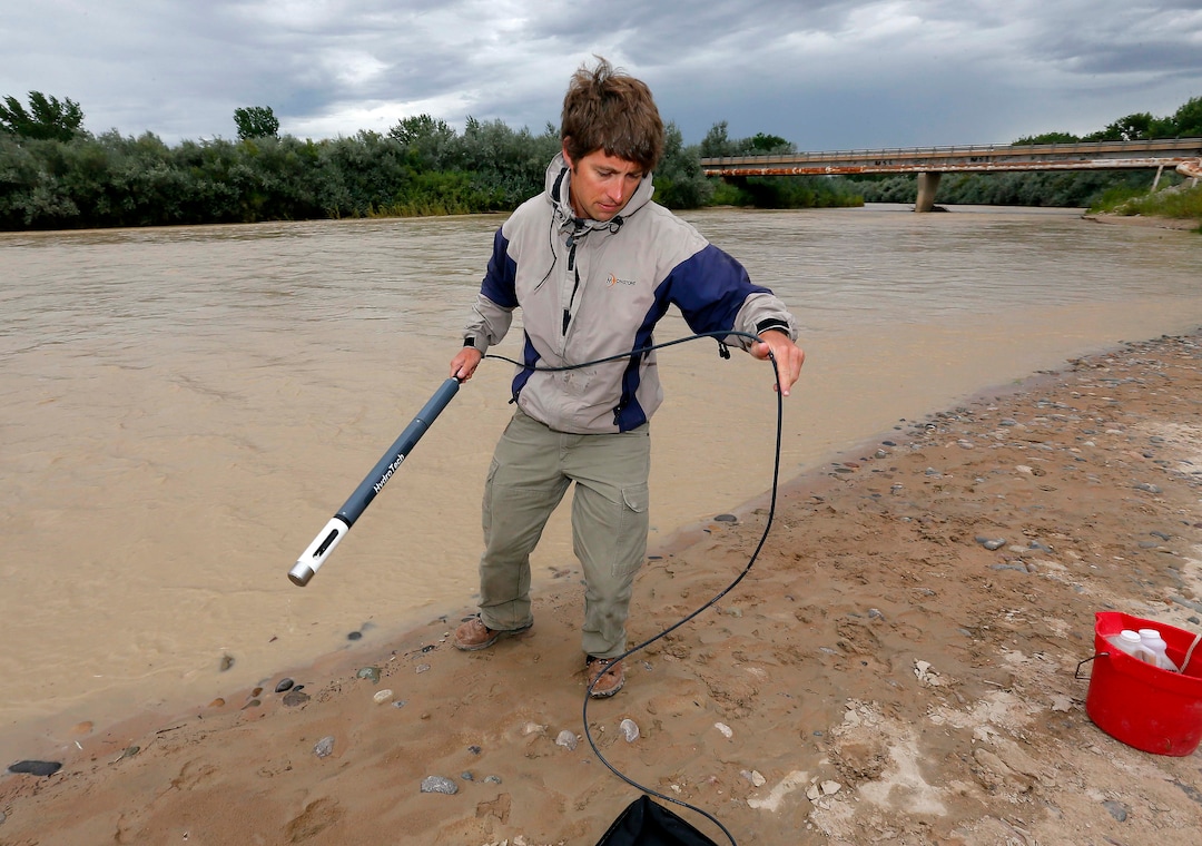 Ben Brown, with the Utah Department of Environmental Quality, takes a pH level reading from a probe in the San Juan River, Tuesday, Aug. 11, 2015, in Montezuma Creek, Utah. A spill containing lead and arsenic from the abandoned Gold King Mine in Silverton, Colo., leaked into the Animas River, which flows into the San Juan River in southern Utah, on Aug. 5. The spill was caused by a mining and safety team working for the EPA.  (AP Photo/Matt York) 
