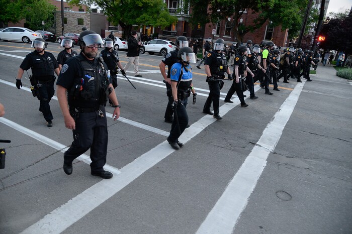 (Francisco Kjolseth  |  The Salt Lake Tribune) Police push forward along 300 East downtown as they enforce a mandatory curfew in Salt Lake City on Monday, June 1, 2020, following violence and unrest over the weekend due to the death of George Floyd by police.