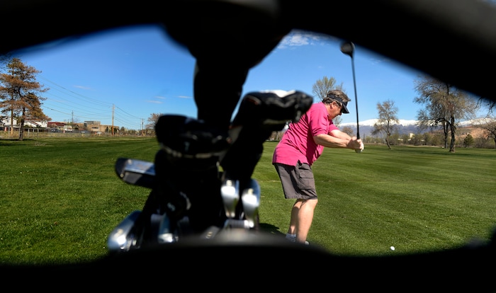 (Leah Hogsten | The Salt Lake Tribune) John Stafsholt fires off the fairway at Rose Park Golf Course while playing with a friend, April 9, 2020.