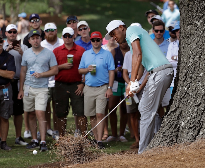 Tony Finau hits from the pine straw on the fifth hole during the final round of the PGA Championship golf tournament at the Quail Hollow Club Sunday, Aug. 13, 2017, in Charlotte, N.C. (AP Photo/Chris O'Meara)