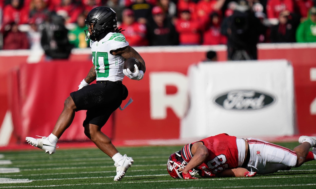 (Francisco Kjolseth  |  The Salt Lake Tribune) Oregon Ducks running back Jordan James (20) gets past Utah Utes safety Sione Vaki (28) as the Utah Utes host the Oregon Ducks, NCAA football in Salt Lake City on Saturday, Oct. 28, 2023.