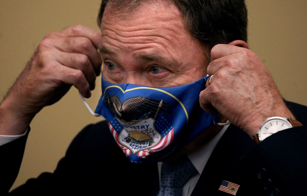 (Laura Seitz | Deseret News, pool) Utah Gov. Gary Herbert puts on a face covering after speaking at a press conference at the Capitol in Salt Lake City on Thursday, July 9, 2020. The governor announced that he is expanding face mask requirements to all schools, but he did not make a general requirement statewide.