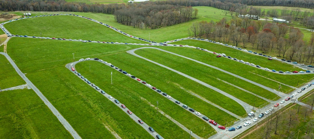 (Andrew Rush | Pittsburgh Post-Gazette via AP) Hundreds of cars wait in line for a food bank distribution at the Big Butler Fairgrounds on Tuesday, April 28, 2020, in Prospect, Pa. The Greater Pittsburgh Community Food Bank expected more than 1,500 vehicles to come to receive two 25-pound boxes of food each.