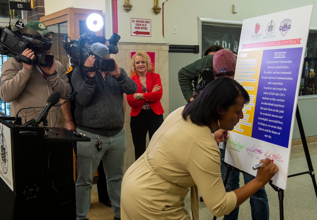(Rick Egan  |  The Salt Lake Tribune)       Rep. Sandra Hollins signs the school resource officer contract at West High School, Tuesday, March 26, 2019.