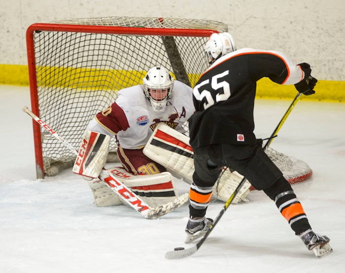 (Steve Griffin  |  The Salt Lake Tribune) Murray's Dillon Hale shots the puck between his legs as Viewmont goalie Keaton Morrison guards the net during the Division 1 ice hockey state title game at the Salt Lake City Sports Complex in Salt Lake City Tuesday Feb. 20, 2018.