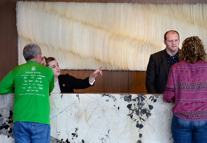 (Scott Sommerdorf | The Salt Lake Tribune)
Camille, left, and Jacob Hollingsworth help guests at the reception desk at the new AC Hotel in downtown Salt Lake City, Friday, April 20, 2018. Hotels and other lodging properties had 11 percent more employees last month than in the previous March, helping to lead Utah to a 3.3 percent year-over-year job growth rate, the best in the nation.
