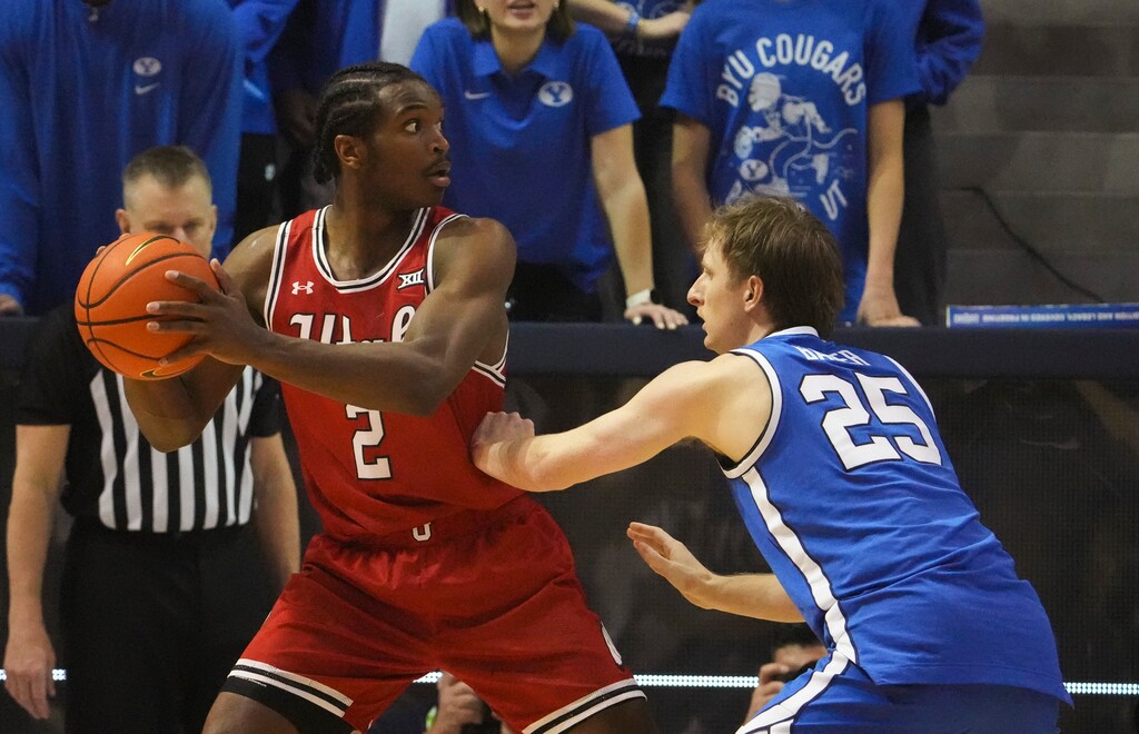 (Bethany Baker  |  The Salt Lake Tribune) Utah Utes forward Ezra Ausar (2) looks to pass as Brigham Young Cougars guard Dawson Baker (25) defends during the game between the Brigham Young Cougars and the Utah Utes in Provo on Saturday, March 8, 2025.