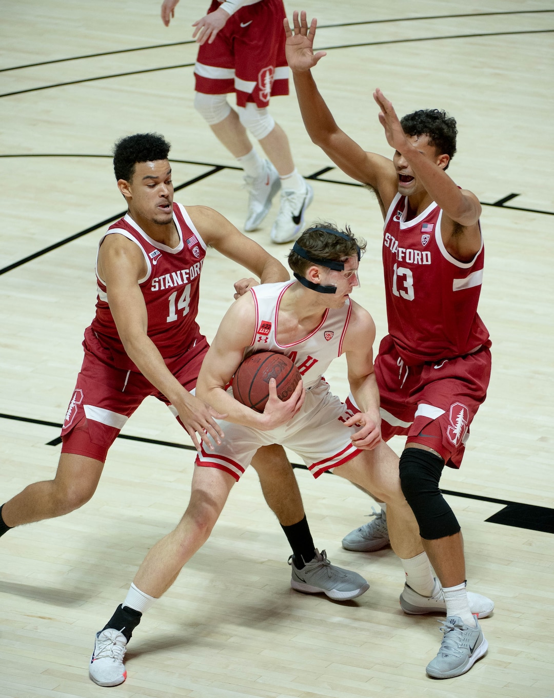 (Francisco Kjolseth  | The Salt Lake Tribune) Utah Utes forward Mikael Jantunen (20) is pressured by Stanford Cardinal forward Spencer Jones (14) and Stanford Cardinal forward Oscar da Silva (13) as the Utes host the Stanford Cardinals on Thursday, Jan. 14, 2021 at the Jon M. Huntsman Center in Salt Lake City.
