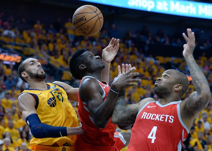 (Francisco Kjolseth | The Salt Lake Tribune) Utah Jazz center Rudy Gobert (27) scrambles for the ball against Houston Rockets center Clint Capela (15) and Houston Rockets forward PJ Tucker (4) in Game 4 of the NBA playoffs at the Vivint Smart Home Arena Sunday, May 6, 2018 in Salt Lake City.
