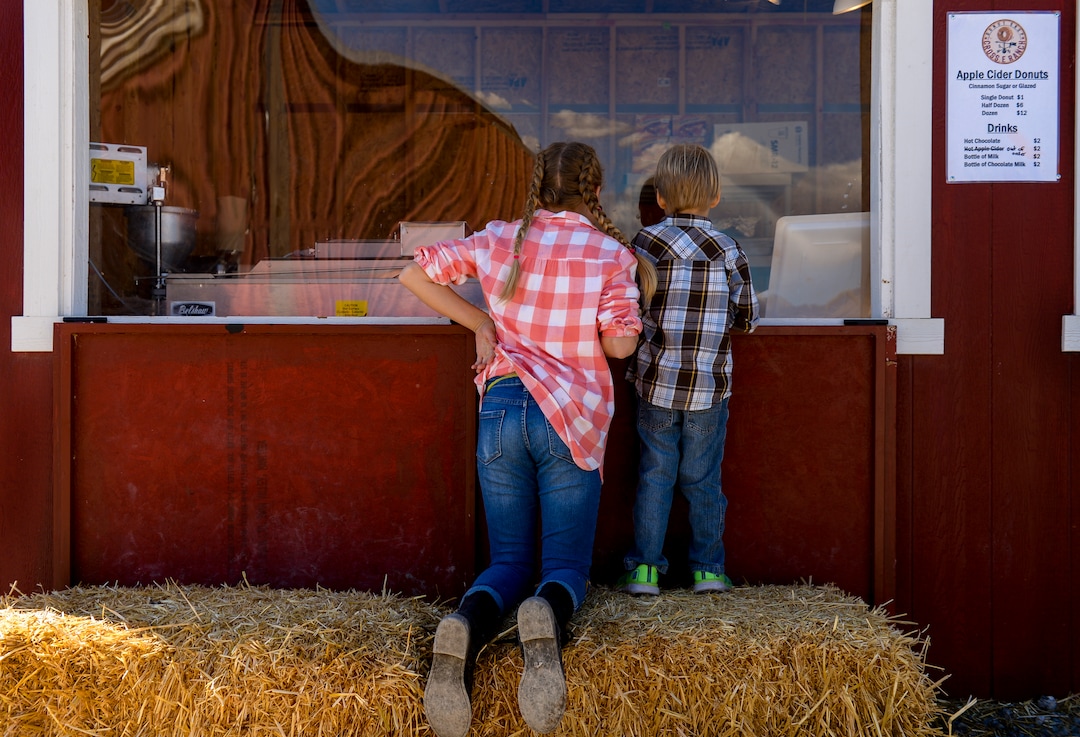 Leah Hogsten  |  The Salt Lake Tribune l-r June Holley, 11, and her brother Lewis, 4, watch as apple cider donuts cook in the fryer during the 2018 Fall Festival at Cross E Ranch in Salt Lake City, Thursday Oct. 18, 2018. 