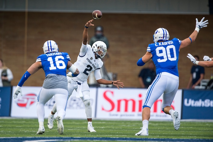 (Chris Detrick  |  The Salt Lake Tribune)  Utah State Aggies quarterback Kent Myers (2) throws the ball past Brigham Young Cougars defensive lineman Sione Takitaki (16) and Brigham Young Cougars defensive lineman Corbin Kaufusi (90) during the game at Merlin Olsen Field at Maverik Stadium Friday, September 29, 2017.