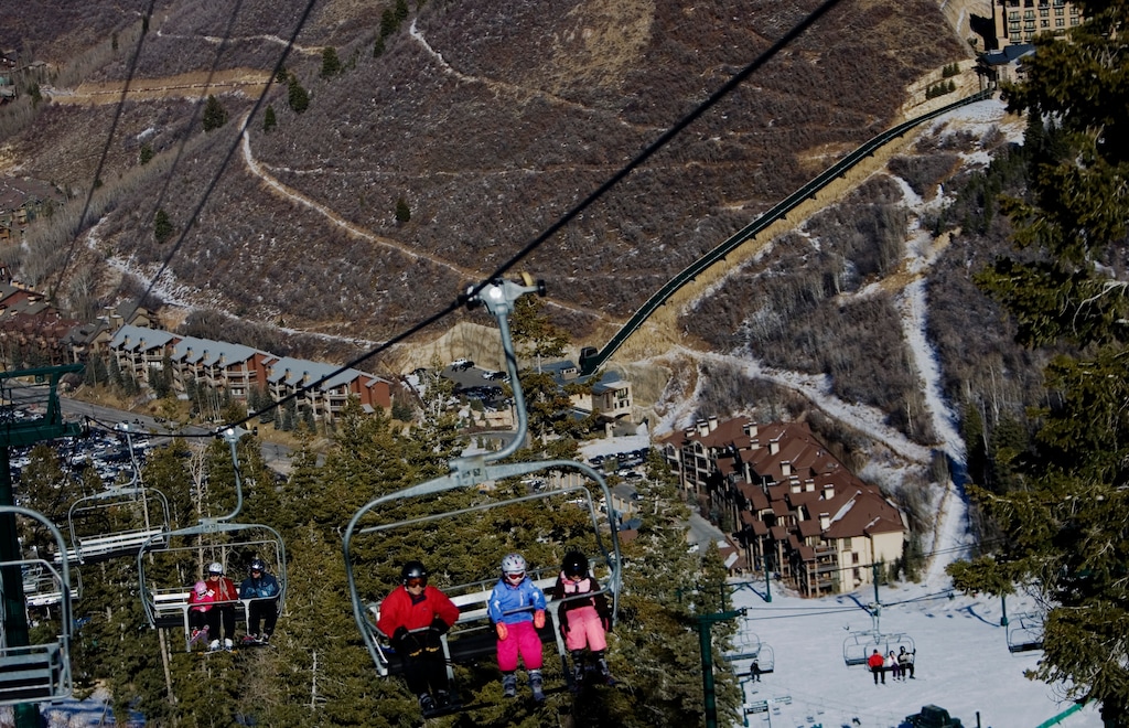 (Tribune file photo) Skiers ride the Silver Lake Express with the snowless valley in the background at Deer Valley Resort in Park City, Utah, in 2012. The resort announced Monday, Aug. 21, 2017, that it has been sold to an unnamed company for an undisclosed price.