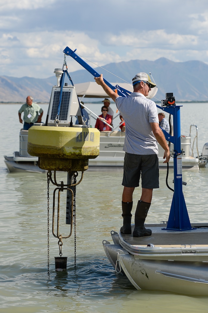 (Francisco Kjolseth | The Salt Lake Tribune) Marshall Baillie, center, with the division of water quality attends one of three Dip Test sensors in Utah Lake used for collecting data on. Members of the Legislative Water Development Commission take a tour of Utah Lake on Wednesday, Sept. 13, 2017, for the purpose of learning of wastewater treatment, the importance of protecting our lakes and rivers, how the state is looking to change water quality standards and how regulation is an important local issue.